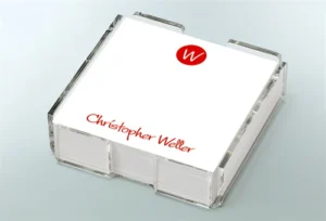 Clear box of personalized notepaper with initials.