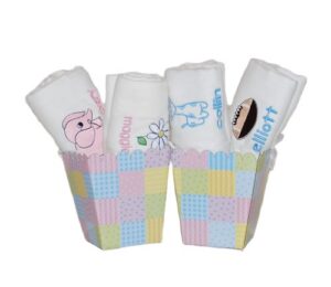 Rolled baby burp cloths in pastel holders