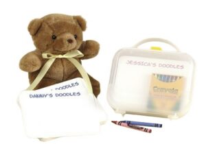 Brown teddy bear with doodle pads and crayons