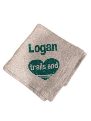Beige folded towel reading "Logan trails end