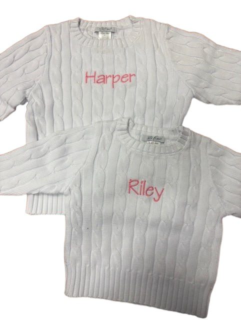 White cable-knit sweaters embroidered "Harper" and "Riley