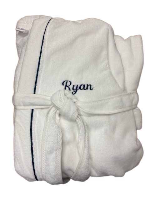 Folded white personalized bathrobe with embroidery