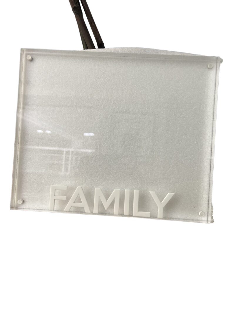 Frosted glass plaque reading "FAMILY