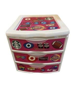 Pink three-drawer storage unit with stickers