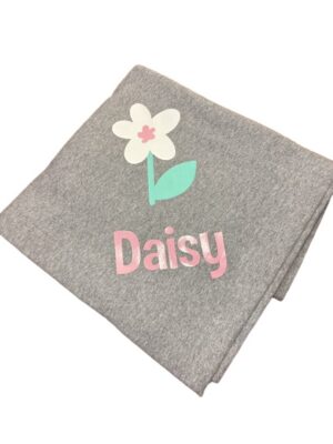 Folded gray blanket with Daisy flower