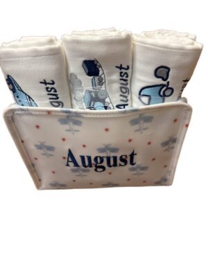 Rolled baby cloths in August holder