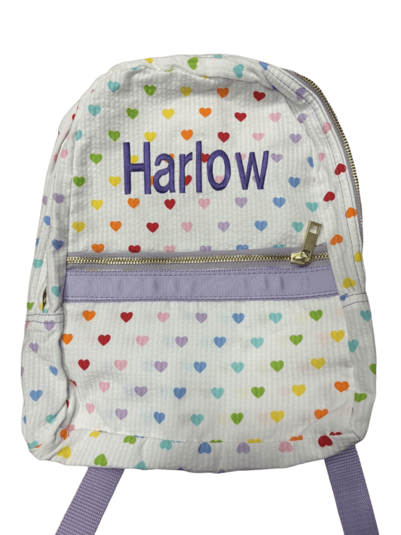White heart-patterned backpack embroidered "Harlow