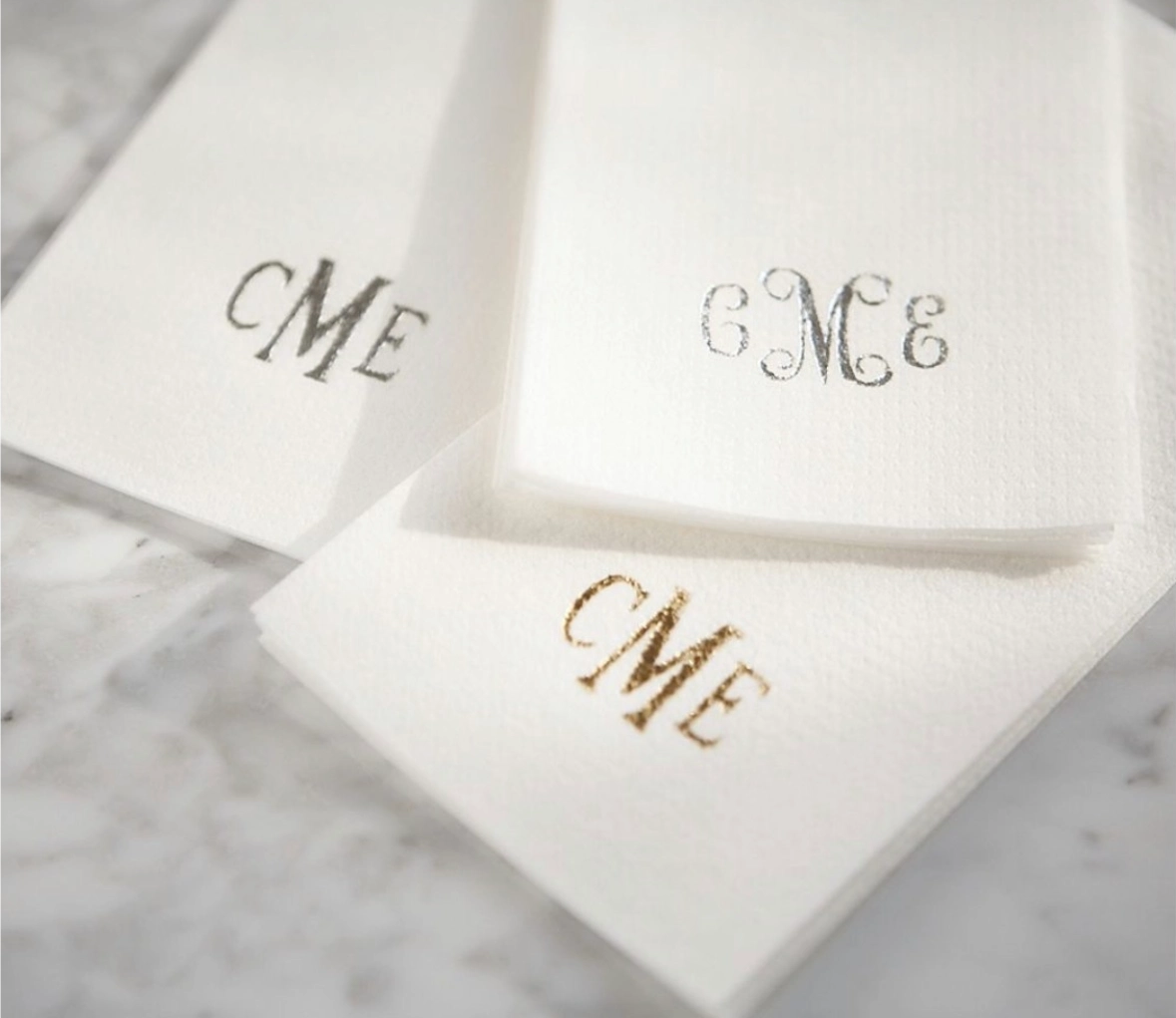 White monogrammed napkins with gold and silver initials